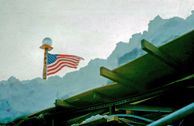 Looking up through collapsed roof area, showing flagpole on top of station