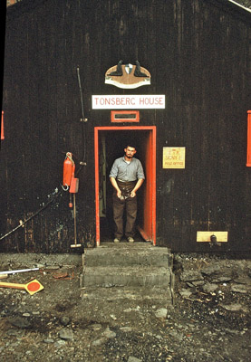 Tonsberg House front door & 'coat-of-arms', early 1958. George White [?] in doorway